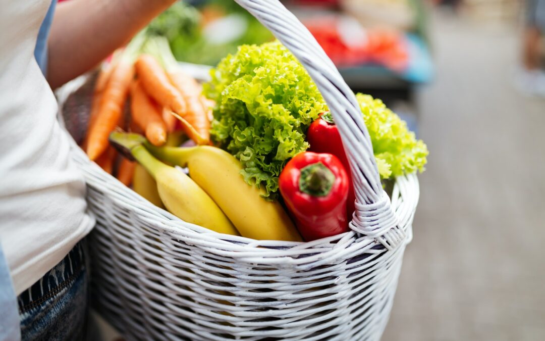 Woman buying fruits and vegetables at local food market