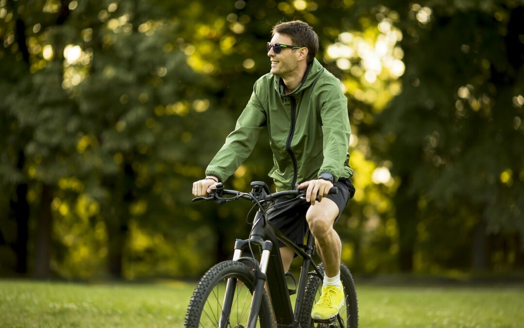 Young man riding ebike in nature
